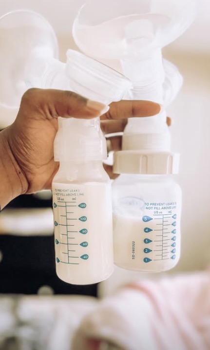 Holding Dr. Brown's baby bottles up to a breast pump