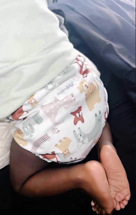 Candid moment of a baby in a patterned cloth diaper