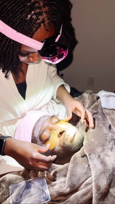 Giving a facial treatment by candlelight with a spa headband